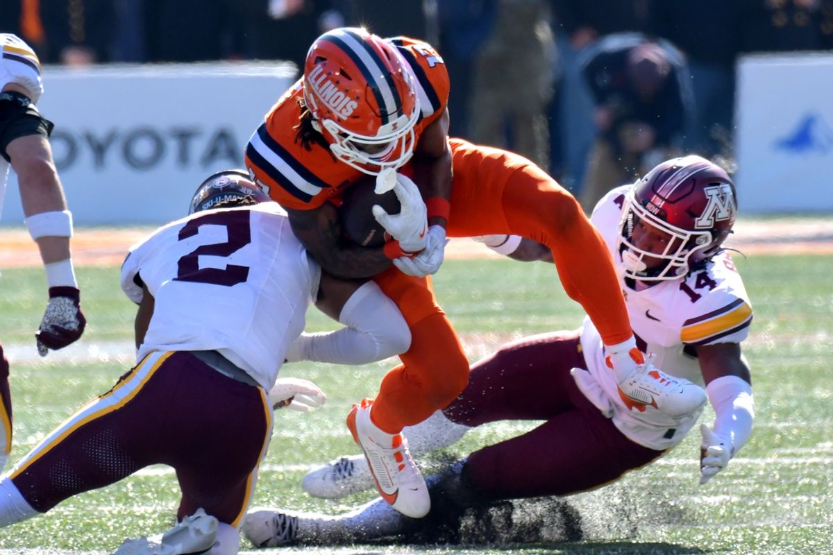 Nov 2, 2024; Champaign, Illinois, USA;  Illinois Fighting Illini wide receiver Pat Bryant (13) is tackled by Minnesota Golden Gophers defensive back Ethan Robinson (2) and Kerry Brown (14) during the first half at Memorial Stadium. Mandatory Credit: Ron Johnson-Imagn Images