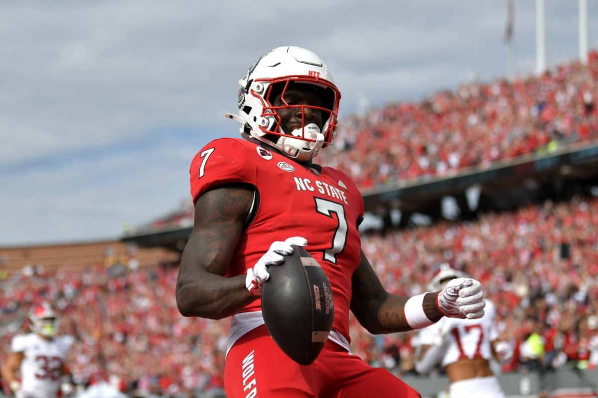 Nov 2, 2024; Raleigh, North Carolina, USA;  North Carolina State Wolfpack running back Jordan Waters (7) celebrates a touchdown in the second half against the Stanford Cardinals during the second half at Carter-Finley Stadium. Mandatory Credit: Zachary Taft-Imagn Images