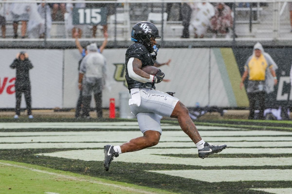 Nov 2, 2024; Orlando, Florida, USA; UCF Knights running back RJ Harvey (7) scores a touchdown against the Arizona Wildcats during the first quarter at FBC Mortgage Stadium. Mandatory Credit: Mike Watters-Imagn Images