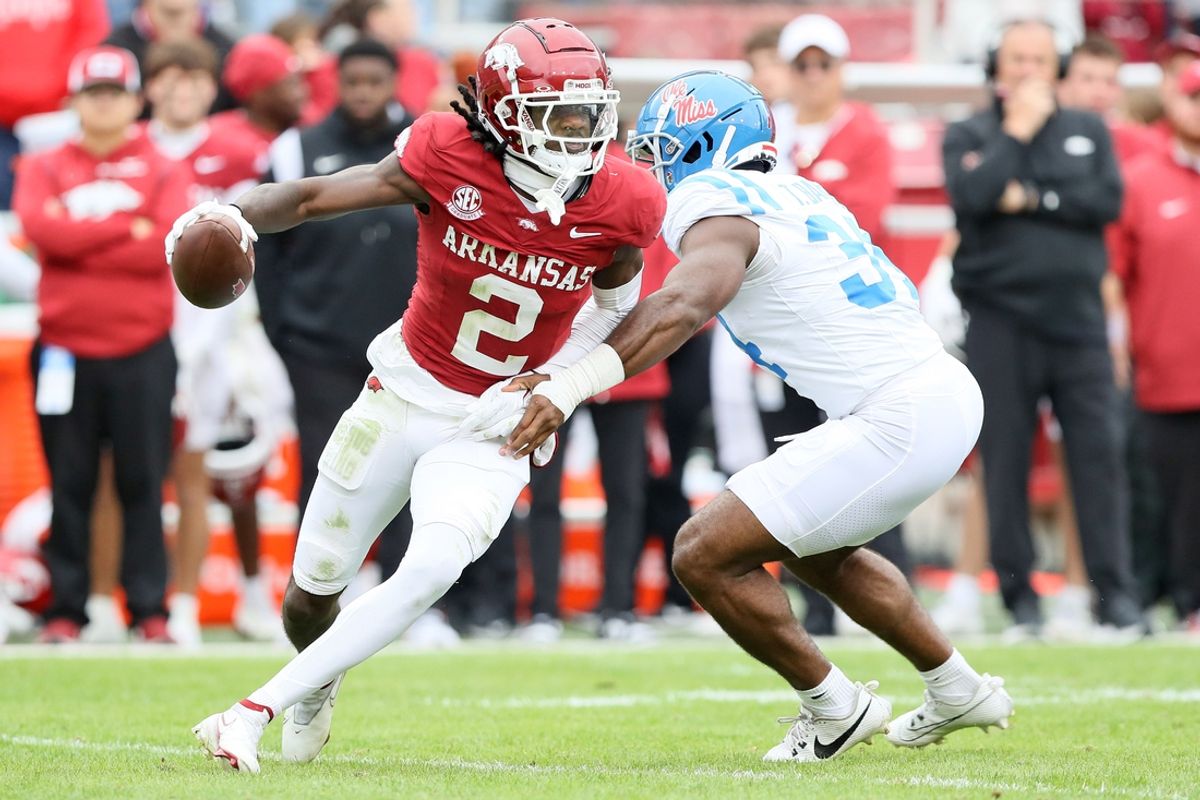 Nov 2, 2024; Fayetteville, Arkansas, USA; Arkansas Razorbackswide receiver Andrew Armstrong (2) runs after a catch in the fourth quarter as Ole Miss Rebels linebacker Tyler Banks (34) defends at Donald W. Reynolds Razorback Stadium. Mississippi won 63-31. Mandatory Credit: Nelson Chenault-Imagn Images
