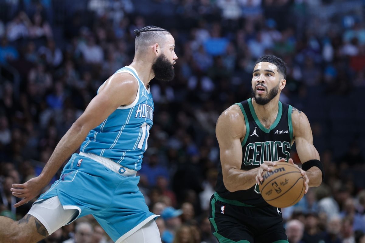 Nov 2, 2024; Charlotte, North Carolina, USA; Boston Celtics forward Jayson Tatum (0) controls the ball against Charlotte Hornets forward Cody Martin (11) during the first quarter at Spectrum Center. Mandatory Credit: Nell Redmond-Imagn Images