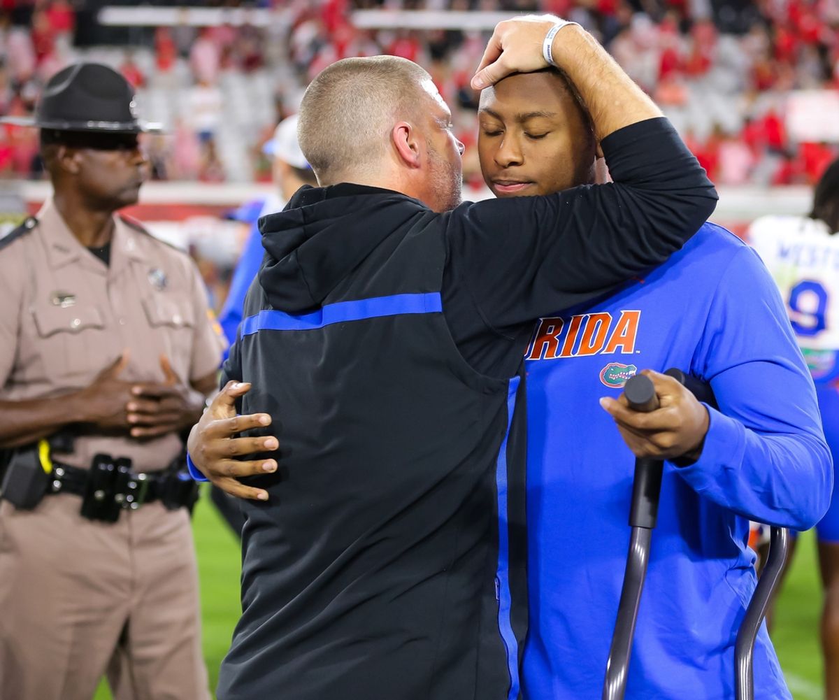 Florida Gators head coach Billy Napier gives an injured Florida Gators quarterback DJ Lagway (2) a hug after the game at EverBank Stadium in Jacksonville, FL on Saturday, November 2, 2024. The Bulldogs defeated the Gators 34-20. [Doug Engle/Gainesville Sun]