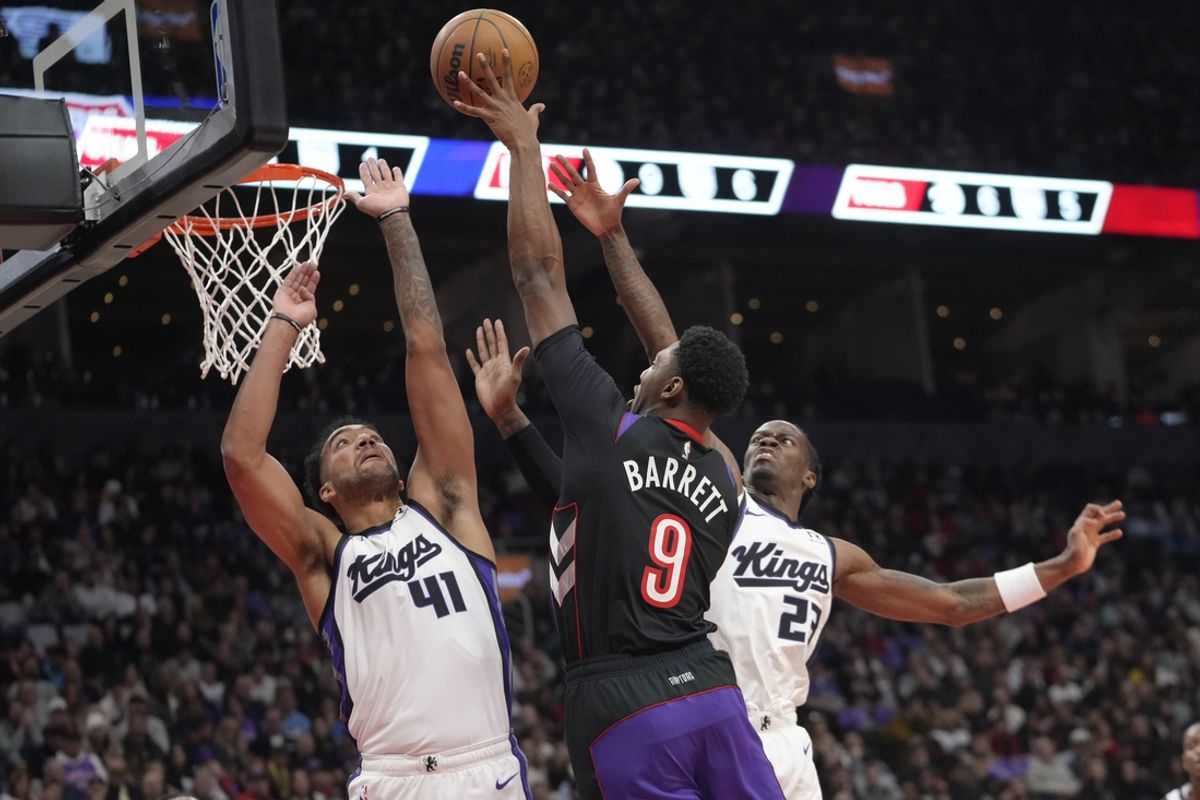Nov 2, 2024; Toronto, Ontario, CAN; Sacramento Kings forward Trey Lyles (41)  and guard Keon Ellis (23) defend against Toronto Raptors guard RJ Barrett (9) during the first half at Scotiabank Arena. Mandatory Credit: John E. Sokolowski-Imagn Images
