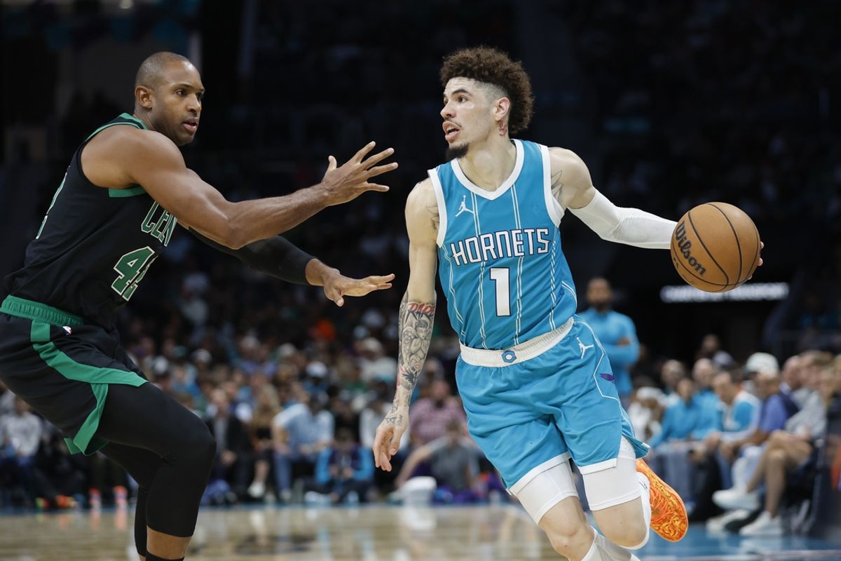 Nov 2, 2024; Charlotte, North Carolina, USA; Charlotte Hornets guard LaMelo Ball (1) drives the baseline against Boston Celtics center Al Horford (42) during the second half at Spectrum Center. Mandatory Credit: Nell Redmond-Imagn Images