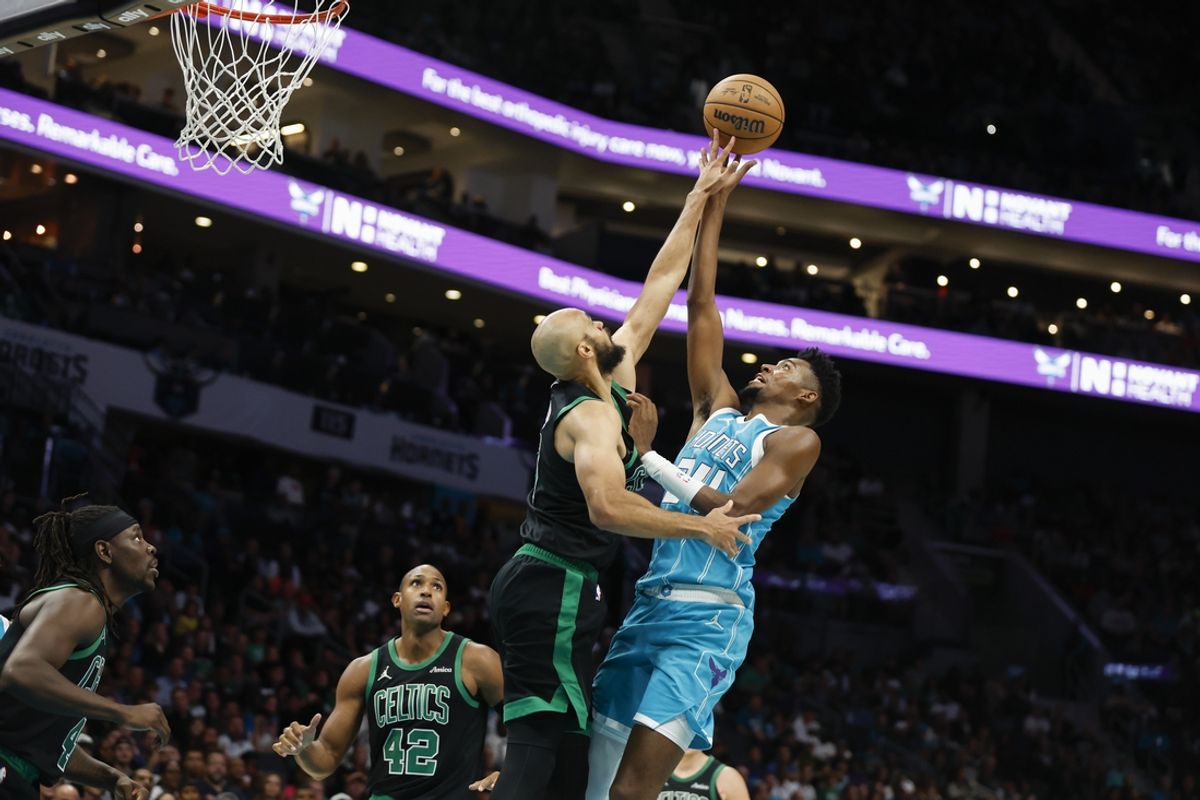 Nov 2, 2024; Charlotte, North Carolina, USA; Charlotte Hornets forward Brandon Miller (24) shoots the ball against Boston Celtics guard Derrick White (9) during the second half at Spectrum Center. Mandatory Credit: Nell Redmond-Imagn Images