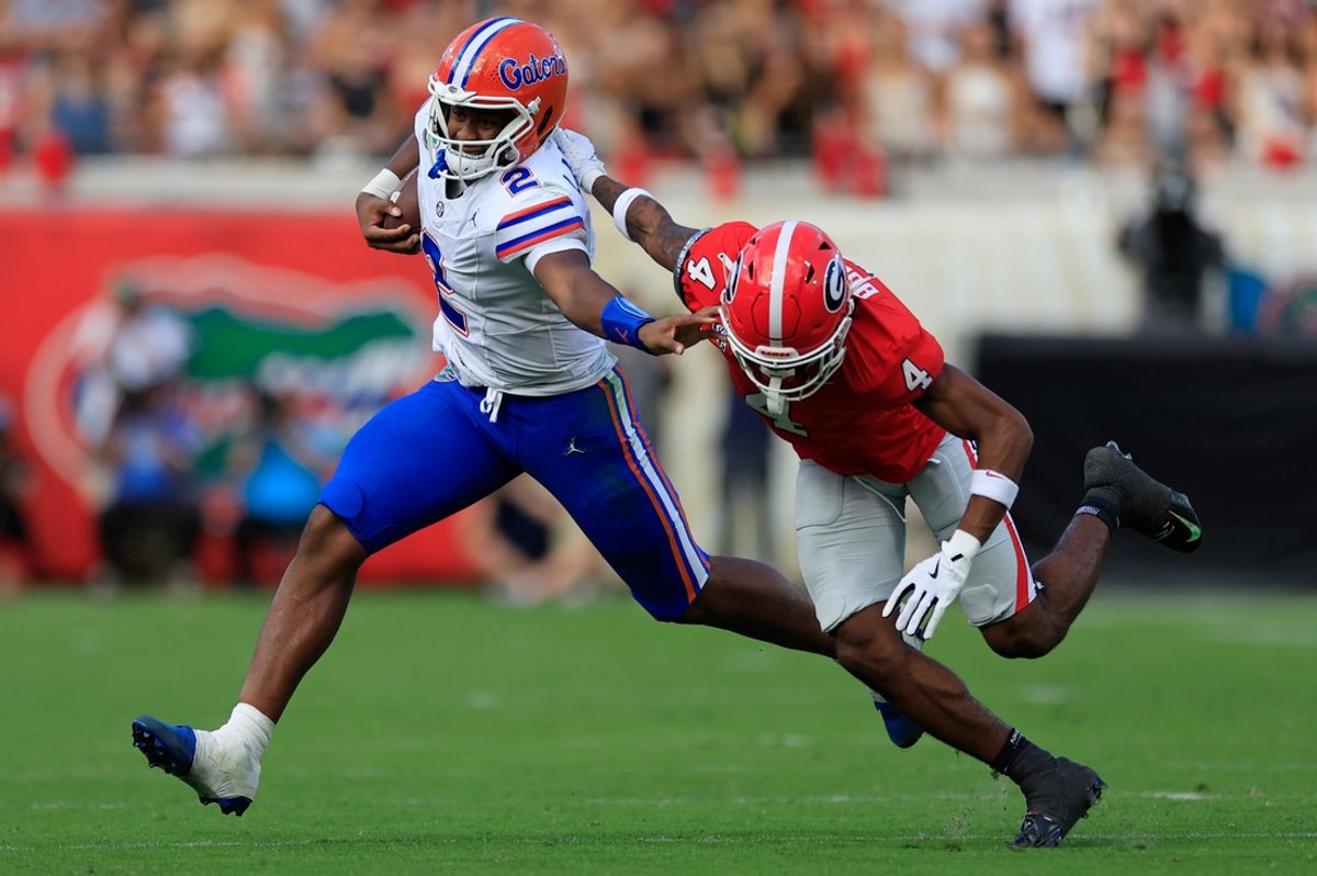 Florida Gators quarterback DJ Lagway (2) fends off Georgia Bulldogs defensive back KJ Bolden (4) during the second quarter of an NCAA college football matchup Saturday, Nov. 2, 2024 at EverBank Stadium in Jacksonville, Fla. The Georgia Bulldogs defeated the Florida Gators 34-20. [Corey Perrine/Florida Times-Union]