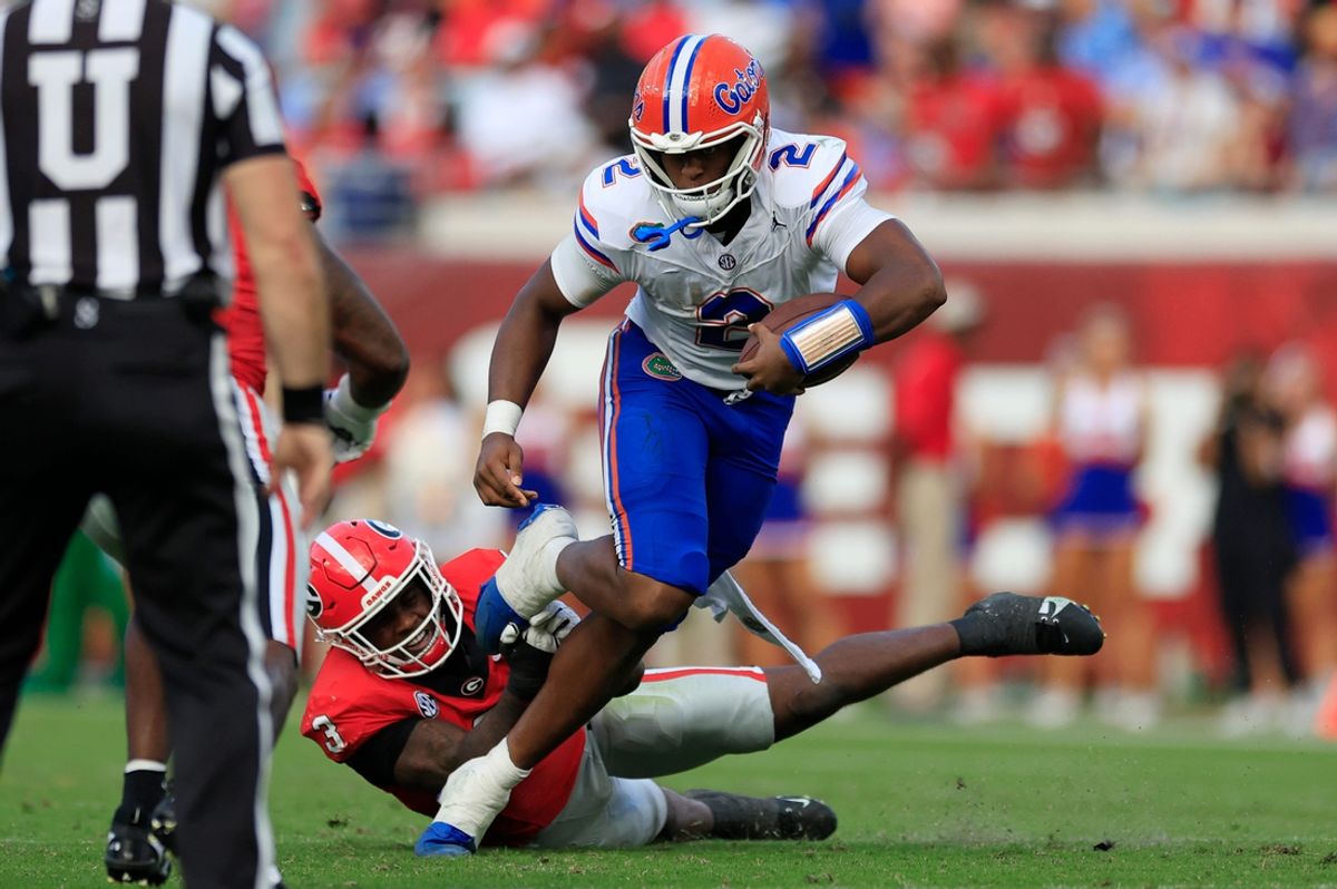 Florida Gators quarterback DJ Lagway (2) rushes for yards against Georgia Bulldogs linebacker CJ Allen (3) during the second quarter of an NCAA college football matchup Saturday, Nov. 2, 2024 at EverBank Stadium in Jacksonville, Fla. The Georgia Bulldogs defeated the Florida Gators 34-20. [Corey Perrine/Florida Times-Union]