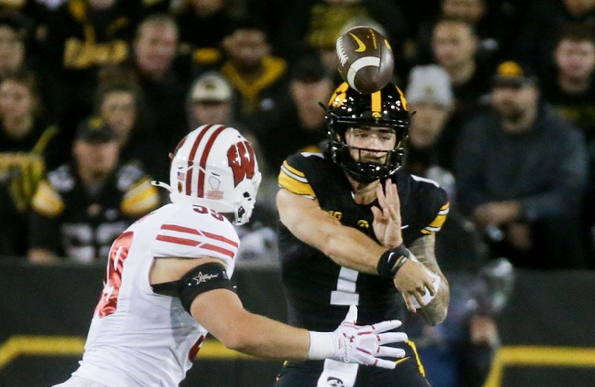 Iowa’s quarterback Brendan Sullivan (1) passes the ball as Wisconsin’s Aaron Witt (59) defends Saturday, Nov. 2, 2024 at Kinnick Stadium in Iowa City, Iowa.
