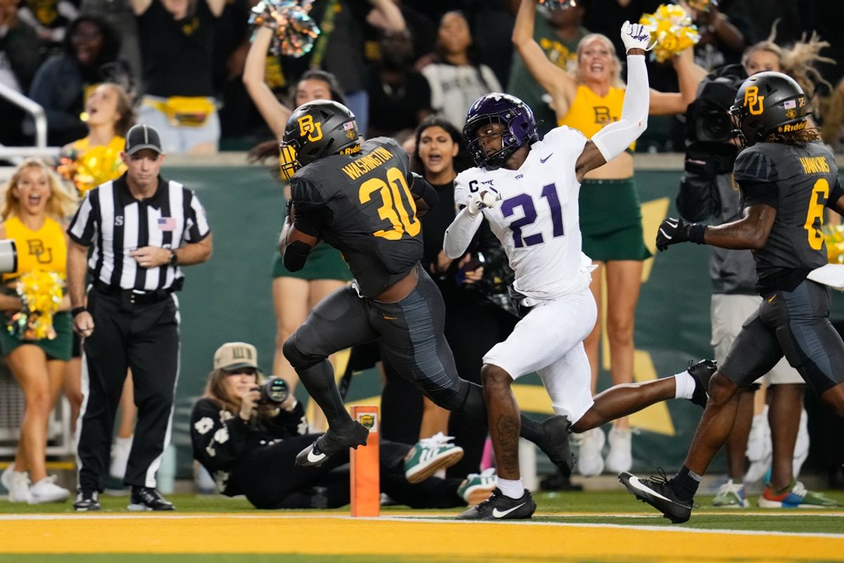Nov 2, 2024; Waco, Texas, USA;  Baylor Bears running back Bryson Washington (30) runs the ball for a 40 yard touchdown as TCU Horned Frogs safety Bud Clark (21) gives chase during the first half at McLane Stadium. Mandatory Credit: Chris Jones-Imagn Images