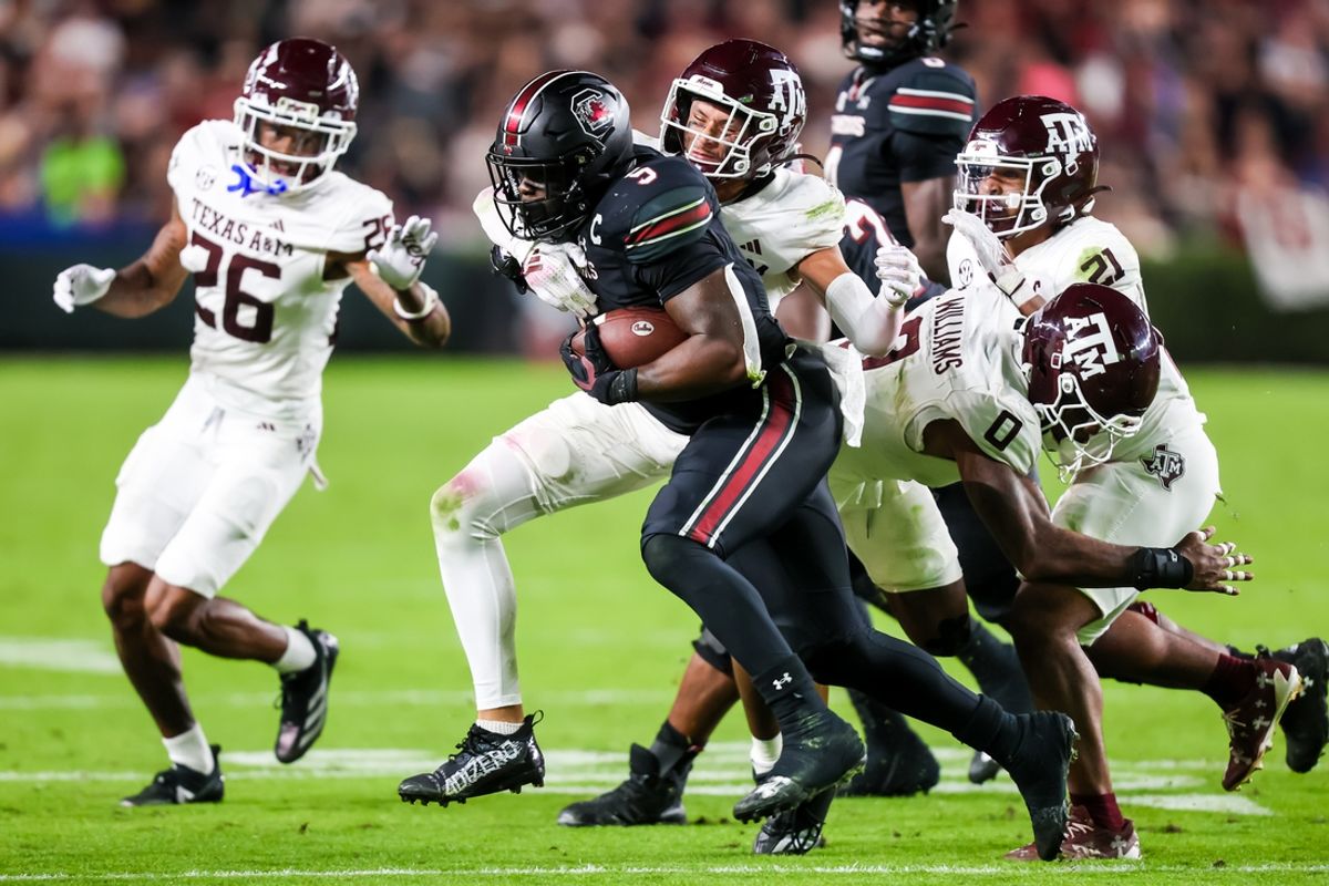 Nov 2, 2024; Columbia, South Carolina, USA; South Carolina Gamecocks running back Raheim Sanders (5) is brought down by Texas A&M Aggies defensive back Marcus Ratcliffe (3) in the second quarter at Williams-Brice Stadium. Mandatory Credit: Jeff Blake-Imagn Images