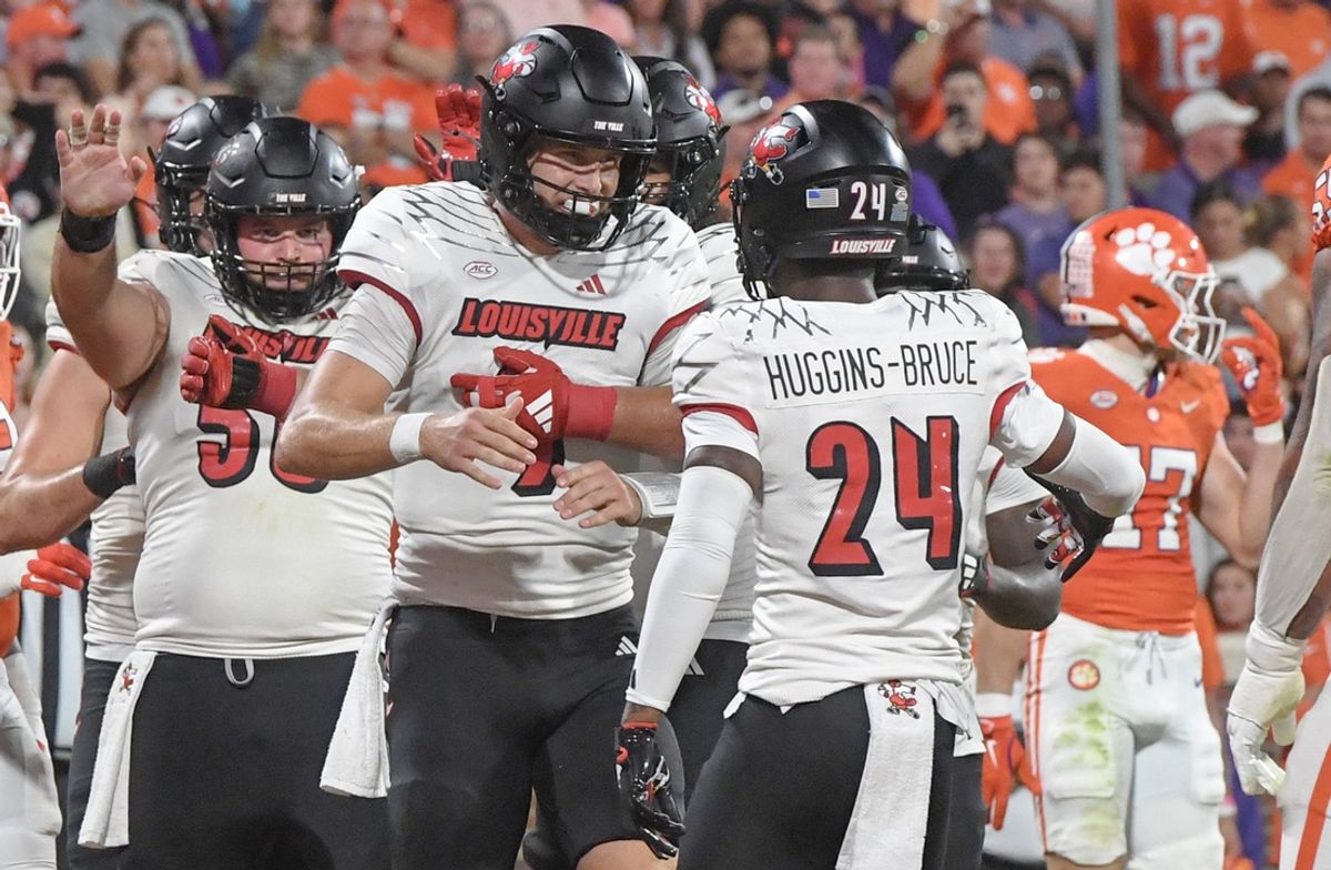 Nov 2, 2024; Clemson, South Carolina, USA; Louisville Cardinals quarterback Tyler Shough (9) celebrates with receiver Ahmari Huggins-Bruce (24) after scoring against the Clemson Tigers during the second quarter at Memorial Stadium. Mandatory Credit: Ken Ruinard-Imagn Images