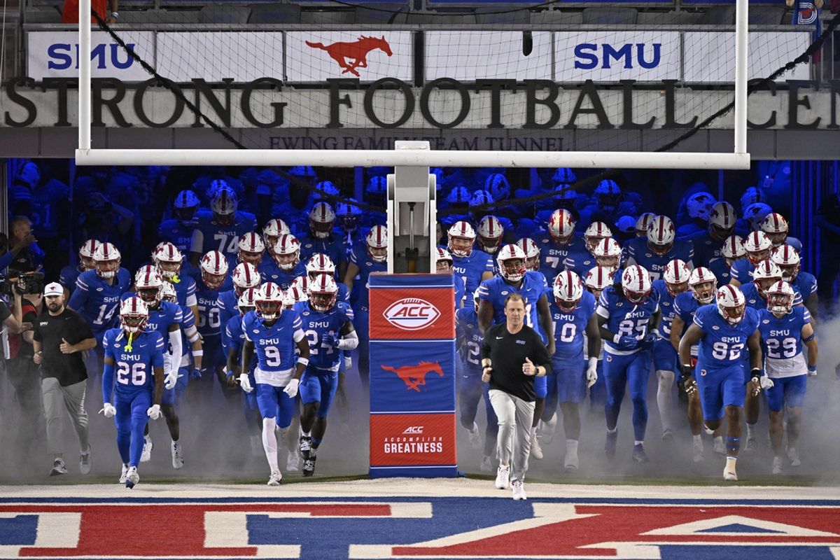 Nov 2, 2024; Dallas, Texas, USA; Southern Methodist Mustangs head coach Rhett Lashlee leads the Mustangs on to the field to face the Pittsburgh Panthers at Gerald J. Ford Stadium. Mandatory Credit: Jerome Miron-Imagn Images