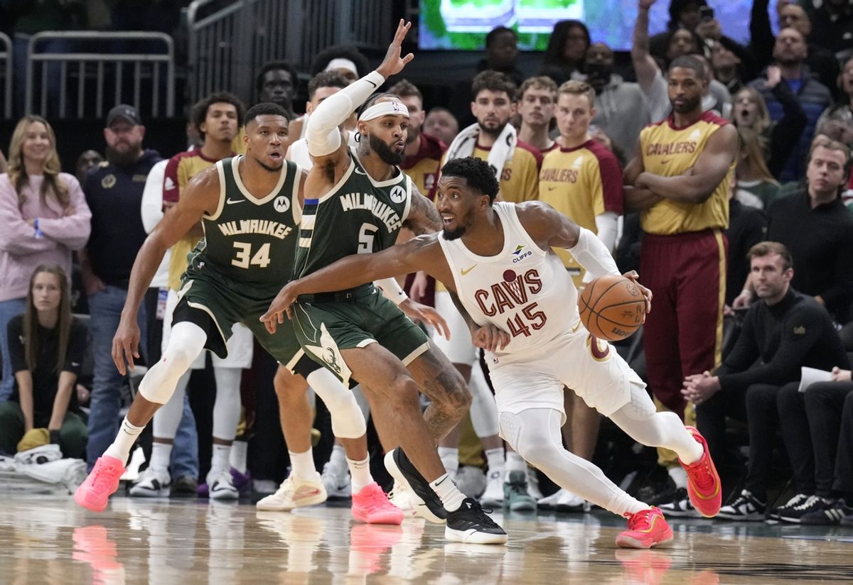 Nov 2, 2024; Milwaukee, Wisconsin, USA; Cleveland Cavaliers guard Donovan Mitchell (45) drives then pulls up for a shot against Milwaukee Bucks guard Gary Trent Jr. (5) with .3 second left on the clock against the Milwaukee Bucks in the fourth quarter at Fiserv Forum. Final Cleveland Cavaliers 114, Milwaukee Bucks 113. Mandatory Credit: Michael McLoone-Imagn Images
