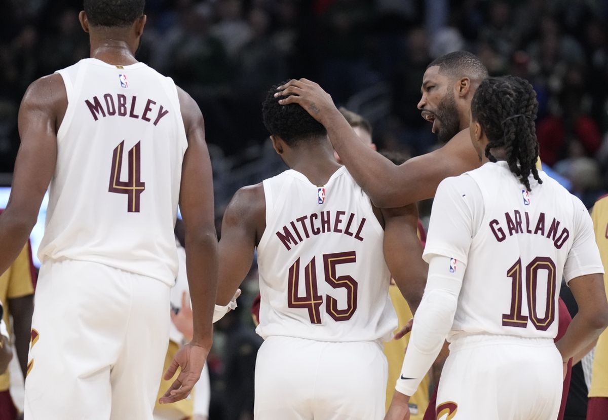 Nov 2, 2024; Milwaukee, Wisconsin, USA; Cleveland Cavaliers guard Donovan Mitchell (45) is congratulated by his teammate after making a basket with .3 seconds on the clock to go ahead of the Milwaukee Bucks 114-113. Which it stayed as the final score at Fiserv Forum. Mandatory Credit: Michael McLoone-Imagn Images