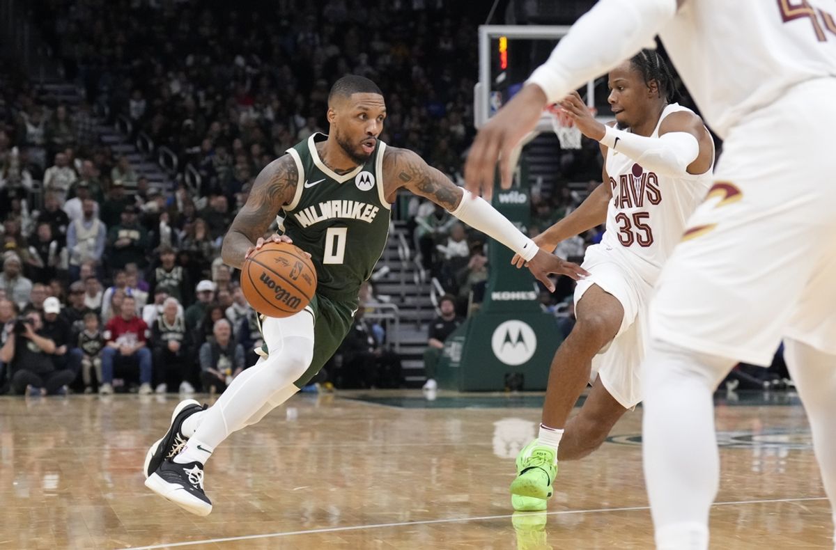 Nov 2, 2024; Milwaukee, Wisconsin, USA; Milwaukee Bucks guard Damian Lillard (0) drives to the basket against Cleveland Cavaliers forward Isaac Okoro (35) one the second half at Fiserv Forum. Mandatory Credit: Michael McLoone-Imagn Images