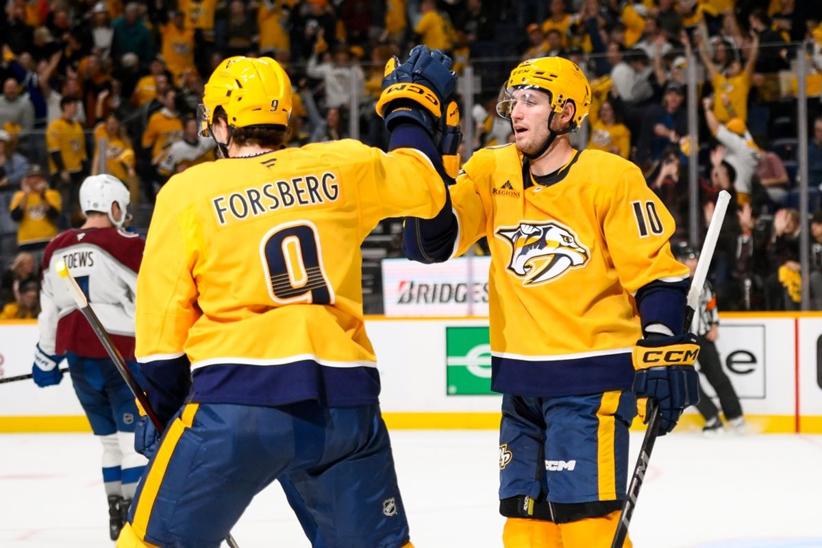 Nov 2, 2024; Nashville, Tennessee, USA;  Nashville Predators left wing Filip Forsberg (9) celebrates his empty net goal with center Colton Sissons (10) against the Colorado Avalanche during the third period at Bridgestone Arena. Mandatory Credit: Steve Roberts-Imagn Images
