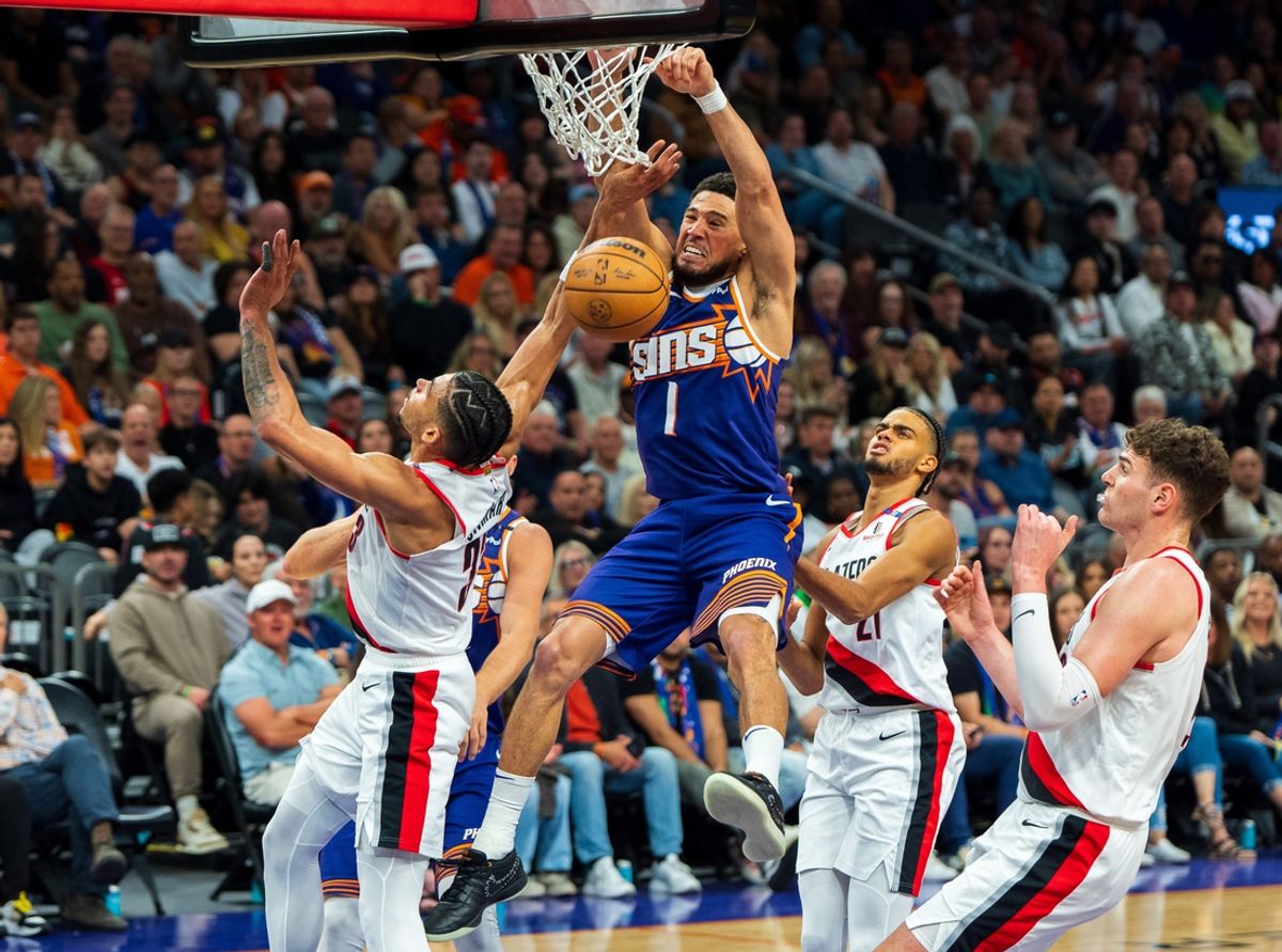 Nov 2, 2024; Phoenix, Arizona, USA;  Phoenix Suns guard Devin Booker (1) slam dunks over Portland Trail Blazers forward Toumani Camara (33) in the second half during a game at Footprint Center. Mandatory Credit: Allan Henry-Imagn Images