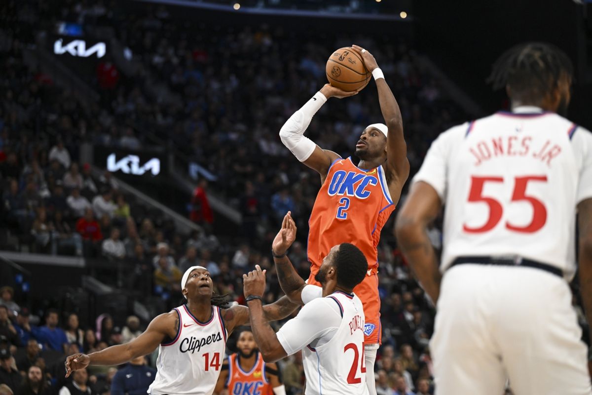 Nov 2, 2024; Inglewood, California, USA; Oklahoma City Thunder guard Shai Gilgeous-Alexander (2) shoots against LA Clippers guard Norman Powell (24) and guard Terance Mann (14) during the second half at Intuit Dome. Mandatory Credit: Jonathan Hui-Imagn Images
