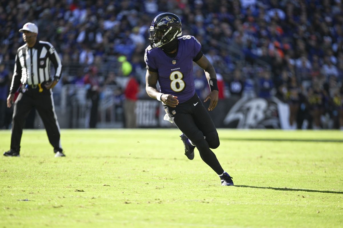 Nov 3, 2024; Baltimore, Maryland, USA;  Baltimore Ravens quarterback Lamar Jackson (8) after a hand off during the first quarter against the Denver Broncos at M&T Bank Stadium. Mandatory Credit: Tommy Gilligan-Imagn Images