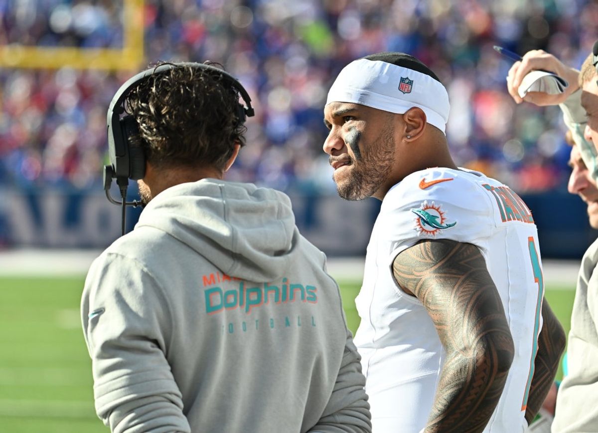 Nov 3, 2024; Orchard Park, New York, USA; Miami Dolphins quarterback Tua Tagovailoa (1) on the sidelines with head coach Mike McDaniel in the second quarter game against the Buffalo Bills at Highmark Stadium. Mandatory Credit: Mark Konezny-Imagn Images
