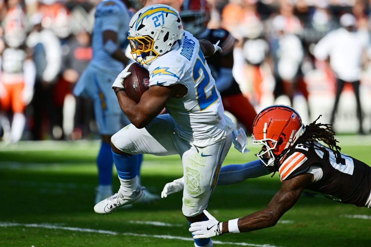 Nov 3, 2024; Cleveland, Ohio, USA; Los Angeles Chargers running back J.K. Dobbins (27) scores a touchdown as Cleveland Browns cornerback Martin Emerson Jr. (23) defends during the first quarter at Huntington Bank Field. Mandatory Credit: Ken Blaze-Imagn Images