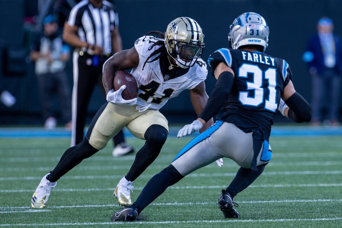 Nov 3, 2024; Charlotte, North Carolina, USA; New Orleans Saints running back Alvin Kamara (41) runs the ball against Carolina Panthers cornerback Caleb Farley (31) during the fourth quarter at Bank of America Stadium. Mandatory Credit: Scott Kinser-Imagn Images