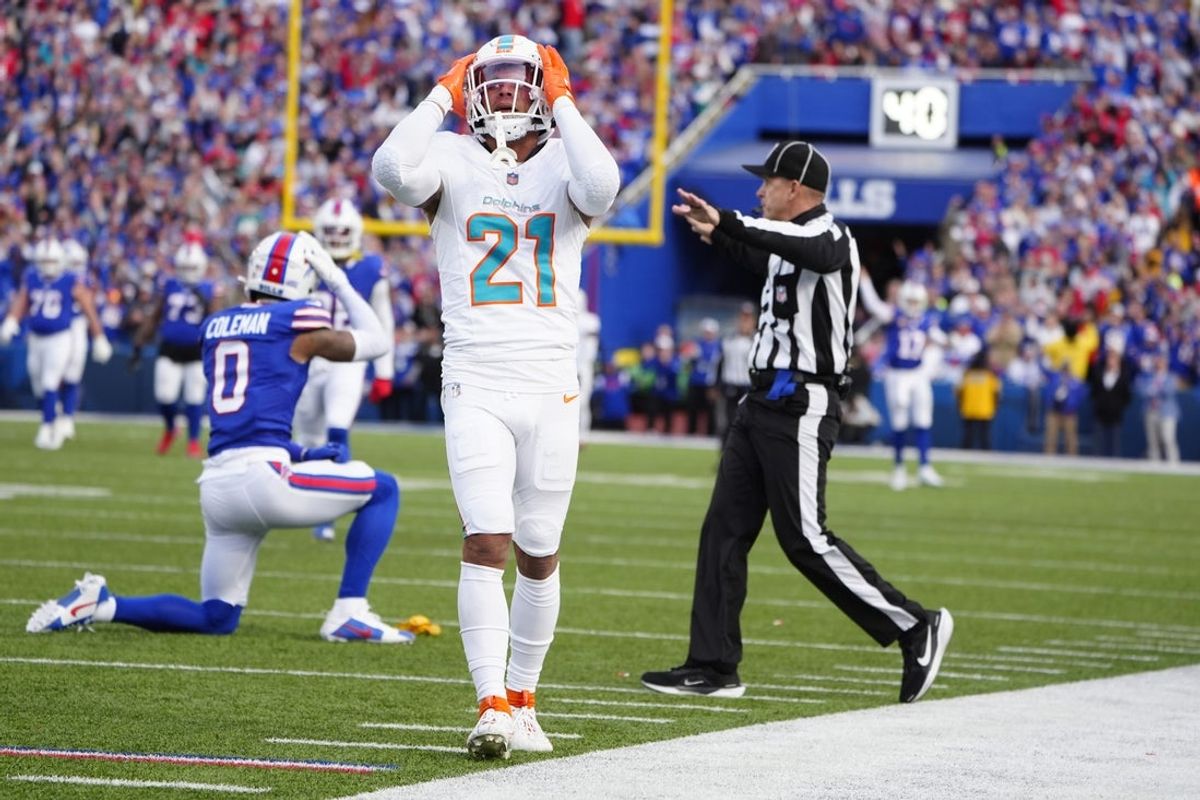 Nov 3, 2024; Orchard Park, New York, USA; Miami Dolphins safety Jordan Poyer (21) reacts to getting penalized on a a hit against Buffalo Bills wide receiver Keon Coleman (0) during the second half at Highmark Stadium. Mandatory Credit: Gregory Fisher-Imagn Images