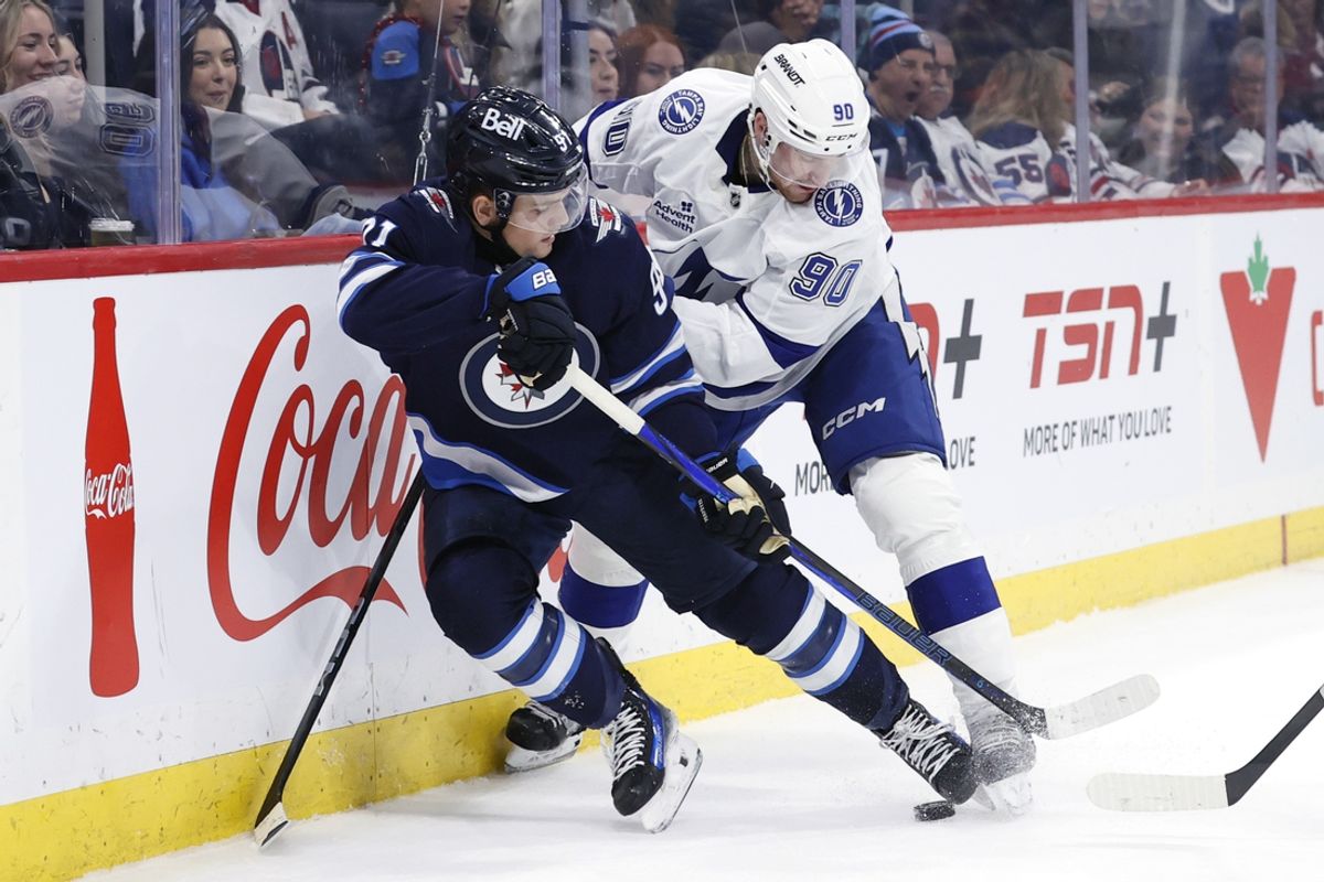 Nov 3, 2024; Winnipeg, Manitoba, CAN; Winnipeg Jets center Cole Perfetti (91) is checked by Tampa Bay Lightning defenseman J.J. Moser (90) in the second period at Canada Life Centre. Mandatory Credit: James Carey Lauder-Imagn Images