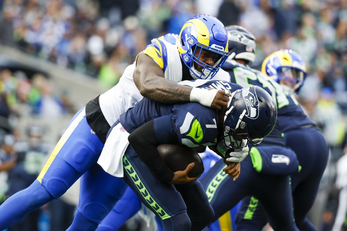Nov 3, 2024; Seattle, Washington, USA; Los Angeles Rams linebacker Jared Verse (8) sacks Seattle Seahawks quarterback Geno Smith (7) during the second quarter at Lumen Field. Mandatory Credit: Joe Nicholson-Imagn Images