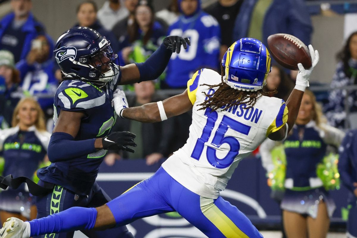Nov 3, 2024; Seattle, Washington, USA; Los Angeles Rams wide receiver Demarcus Robinson (15) catches a game-winning touchdown pass against Seattle Seahawks cornerback Riq Woolen (27) during overtime at Lumen Field. Mandatory Credit: Joe Nicholson-Imagn Images