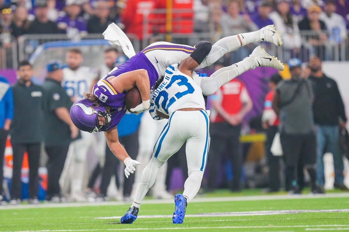 Nov 3, 2024; Minneapolis, Minnesota, USA; Indianapolis Colts cornerback Kenny Moore II (23) tackles Minnesota Vikings tight end T.J. Hockenson (87) in the first quarter at U.S. Bank Stadium. Mandatory Credit: Brad Rempel-Imagn Images
