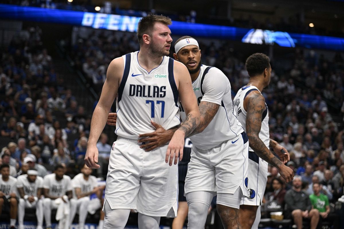 Nov 3, 2024; Dallas, Texas, USA; Dallas Mavericks center Daniel Gafford (21) hugs guard Luka Doncic (77) during the second half against the Orlando Magic at the American Airlines Center. Mandatory Credit: Jerome Miron-Imagn Images