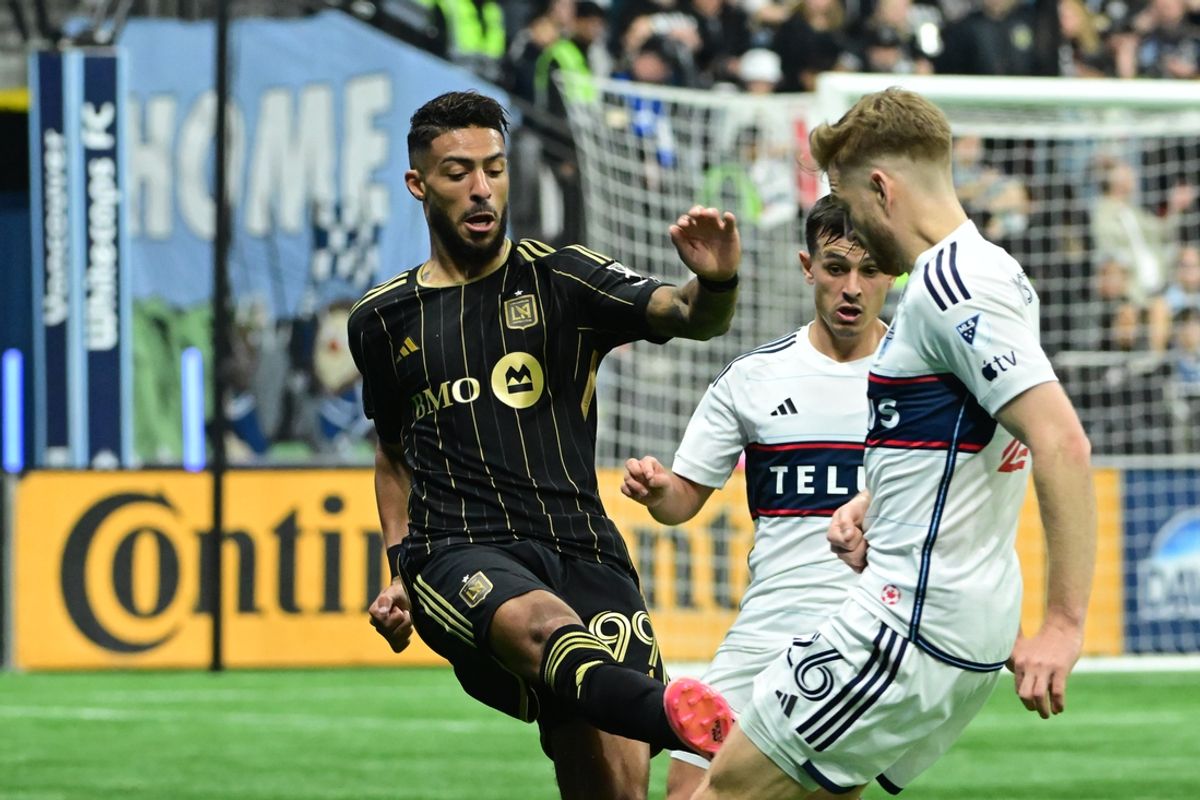 Nov 3, 2024; Vancouver, British Columbia, CAN; LAFC forward Denis Bouanga (99) fouls Vancouver Whitecaps midfielder Stuart Armstrong (26) in the first half  in a 2024 MLS Cup Playoffs Round One match at BC Place. Mandatory Credit: Anne-Marie Sorvin-Imagn Images