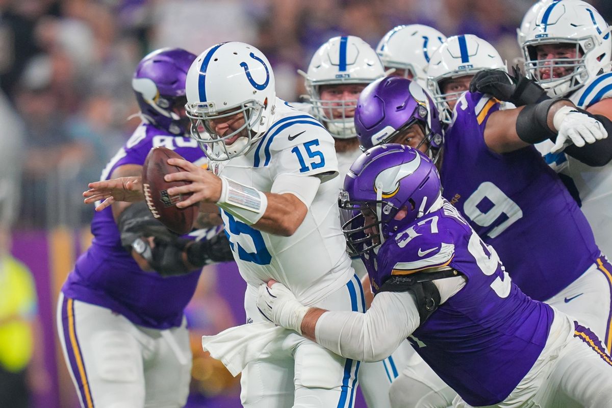 Nov 3, 2024; Minneapolis, Minnesota, USA; Minnesota Vikings defensive tackle Harrison Phillips (97) tackles Indianapolis Colts quarterback Joe Flacco (15) in the fourth quarter at U.S. Bank Stadium. Mandatory Credit: Brad Rempel-Imagn Images