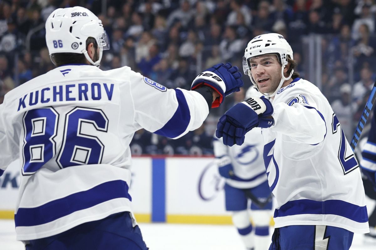 Nov 3, 2024; Winnipeg, Manitoba, CAN; Tampa Bay Lightning center Brayden Point (21) celebrates his first period goal with Tampa Bay Lightning right wing Nikita Kucherov (86) against the Winnipeg Jets at Canada Life Centre. Mandatory Credit: James Carey Lauder-Imagn Images
