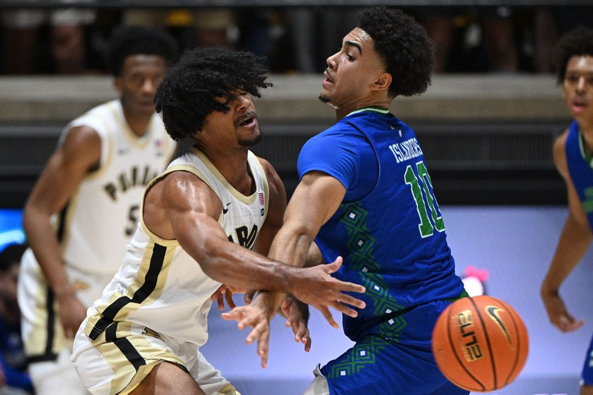Nov 4, 2024; West Lafayette, Indiana, USA; Purdue Boilermakers guard C.J. Cox (0) passes the ball around Texas A&M-CC Islanders guard Isaac Williams (10) during the first half at Mackey Arena. Mandatory Credit: Marc Lebryk-Imagn Images