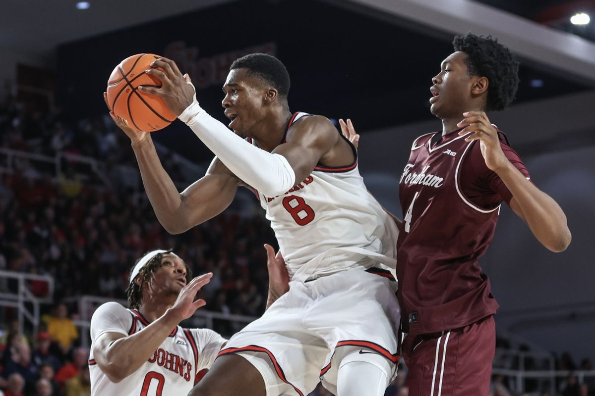Nov 4, 2024; Queens, New York, USA;  St. John's Red Storm center Vince Iwuchukwu (8) jumps in front of Fordham Rams center Jaden Smith (4) to grab a rebound in the first half at Carnesecca Arena. Mandatory Credit: Wendell Cruz-Imagn Images