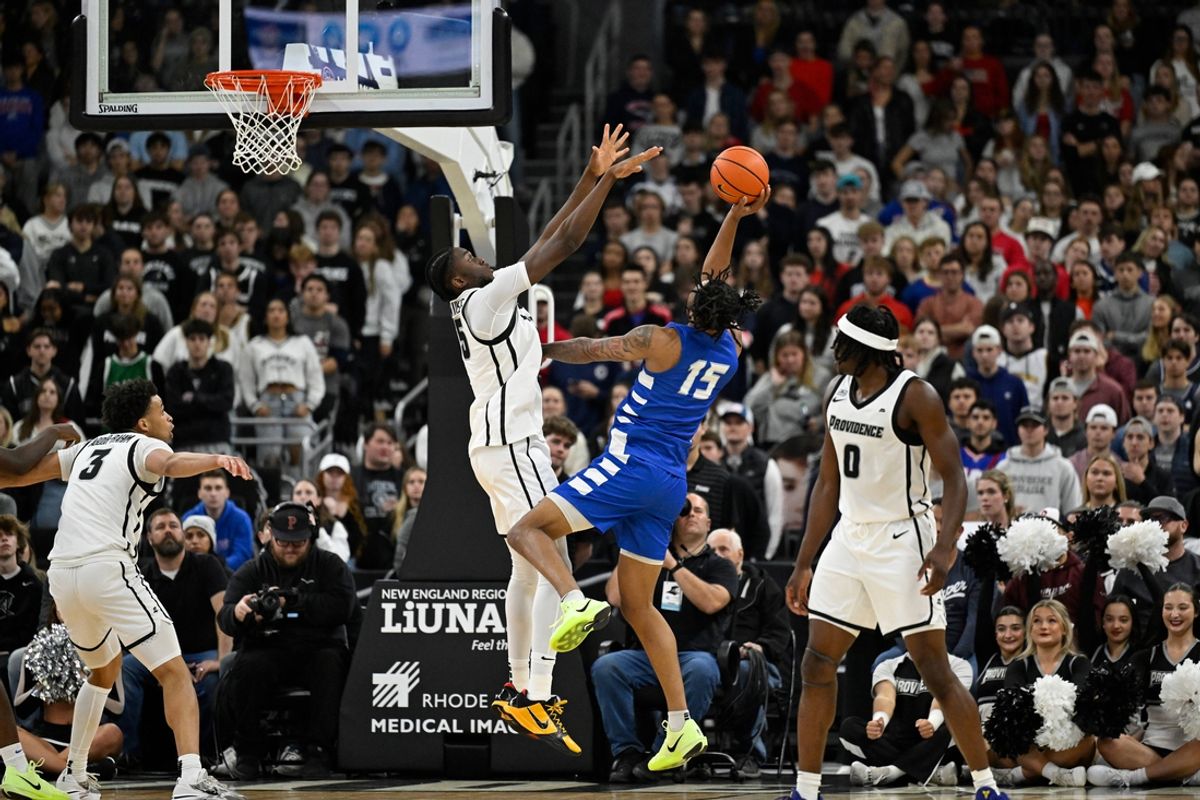 Nov 4, 2024; Providence, Rhode Island, USA; Central Connecticut State Blue Devils forward Jayden Brown (15) shoots over the defense of Providence Friars forward Oswin Erhunmwunse (55) during the first half at Amica Mutual Pavilion. Mandatory Credit: Eric Canha-Imagn Images