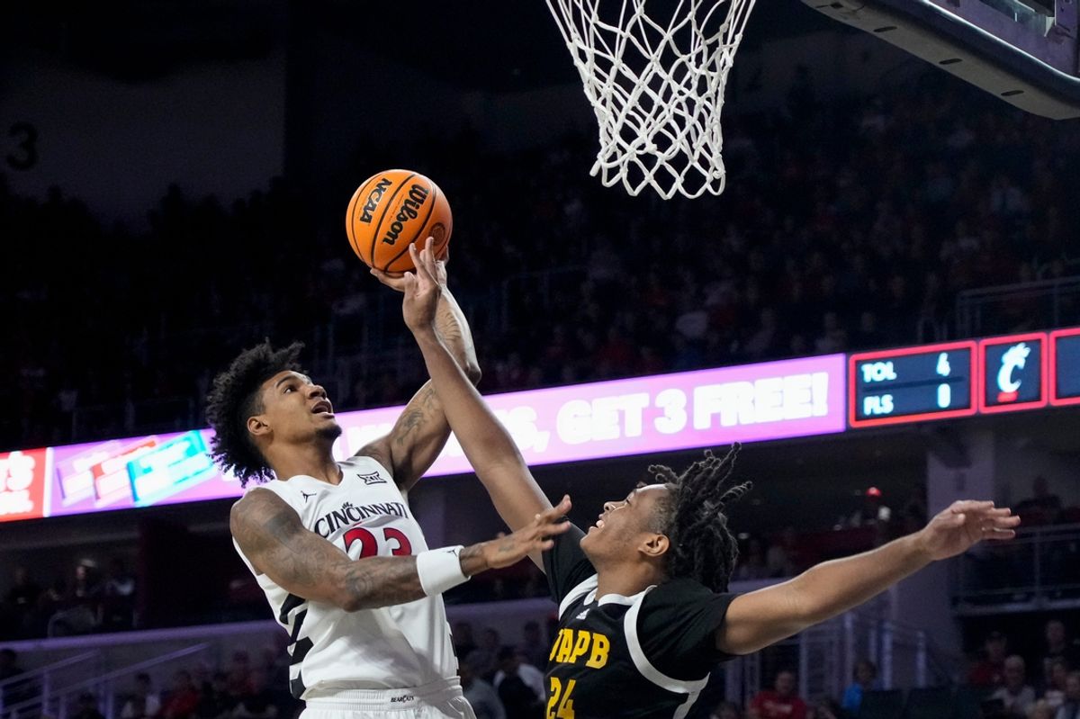 Cincinnati Bearcats forward Dillon Mitchell (23) puts up a shot over Arkansas-Pine Bluff Golden Lions forward Kyle Brown (24) in the first half of the NCAA mens basketball game between the Cincinnati Bearcats and the Arkansas-Pine Bluff Golden Lions at Fifth Third Arena on the University of Cincinnati campus on Monday, Nov. 4, 2024. The Bearcats led 55-32 at halftime.