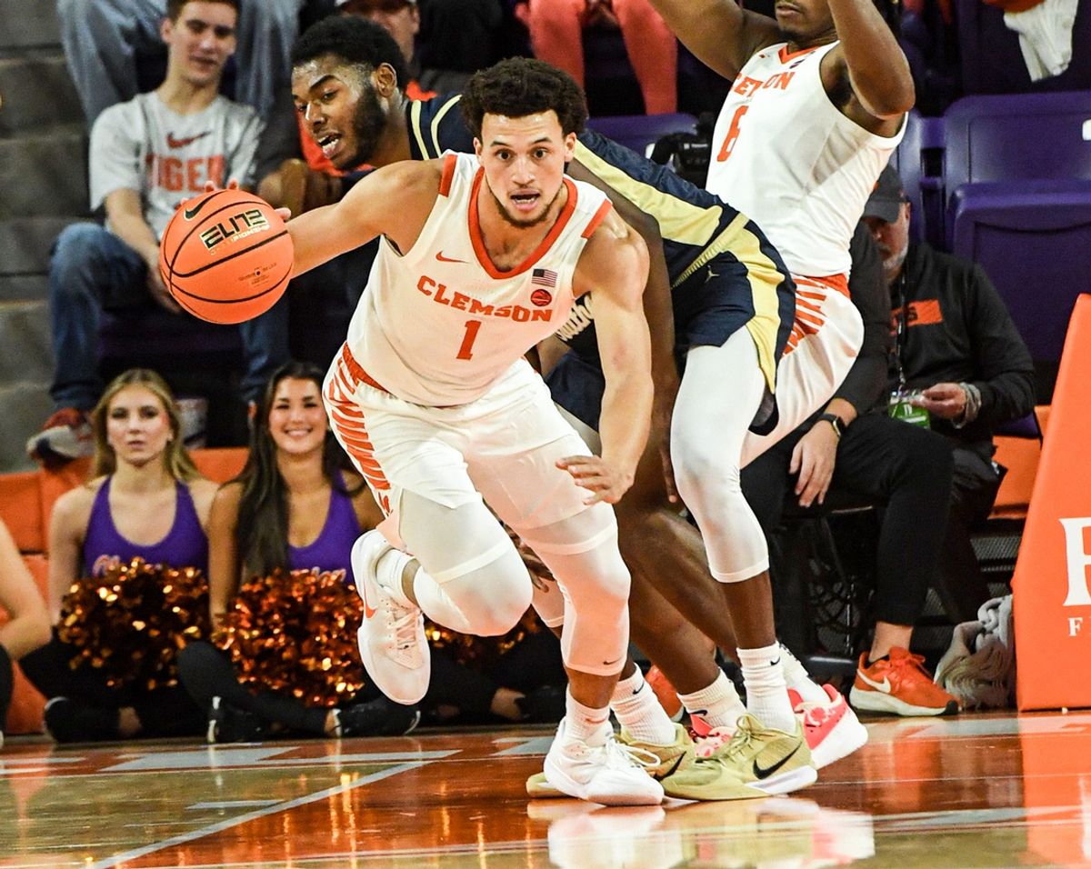 Clemson guard Chase Hunter (1) brings the ball up court near Charleston Southern University guard Lamar Oden Jr (1) during the first half at Littlejohn Coliseum in Clemson, S.C Monday, November 4, 2024.