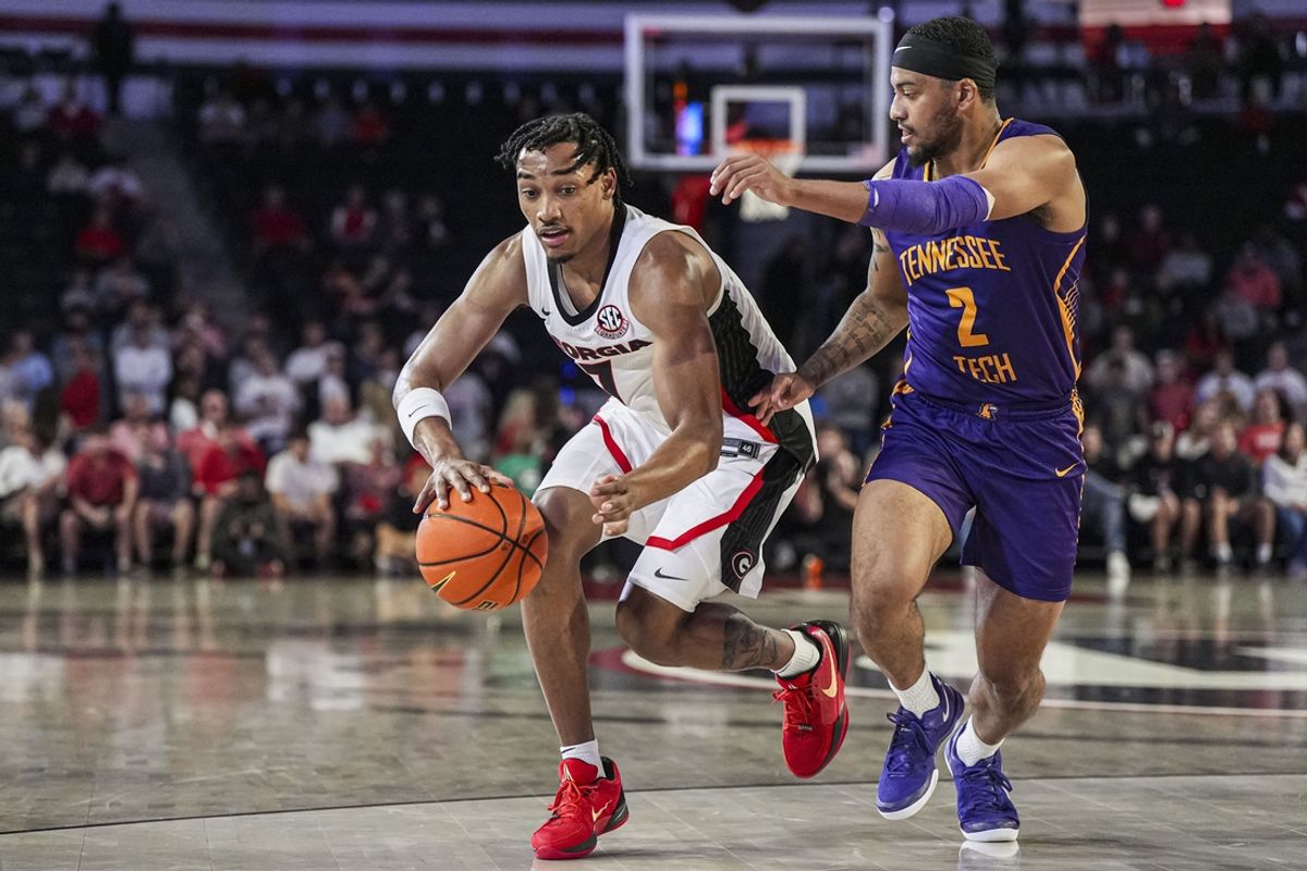 Nov 4, 2024; Athens, Georgia, USA; Georgia Bulldogs guard Tyrin Lawrence (7) dribbles against Tennessee Tech Golden Eagles guard Kyle Layton (2) during the first half at Stegeman Coliseum. Mandatory Credit: Dale Zanine-Imagn Images