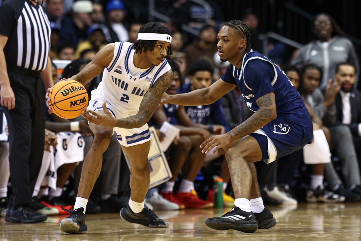 Nov 4, 2024; Newark, New Jersey, USA; Seton Hall Pirates guard Chaunce Jenkins (2) dribbles as St. Peter's Peacocks guard Armoni Zeigler (5) defends during the first half at Prudential Center. Mandatory Credit: Vincent Carchietta-Imagn Images