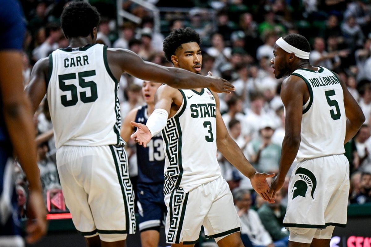 Michigan State's Jaden Akins, center, celebrates with Coen Carr, left, and Tre Holloman after getting fouled on a shot against Monmouth during the second half on Monday, Nov. 4, 2024, at the Breslin Center in East Lansing.