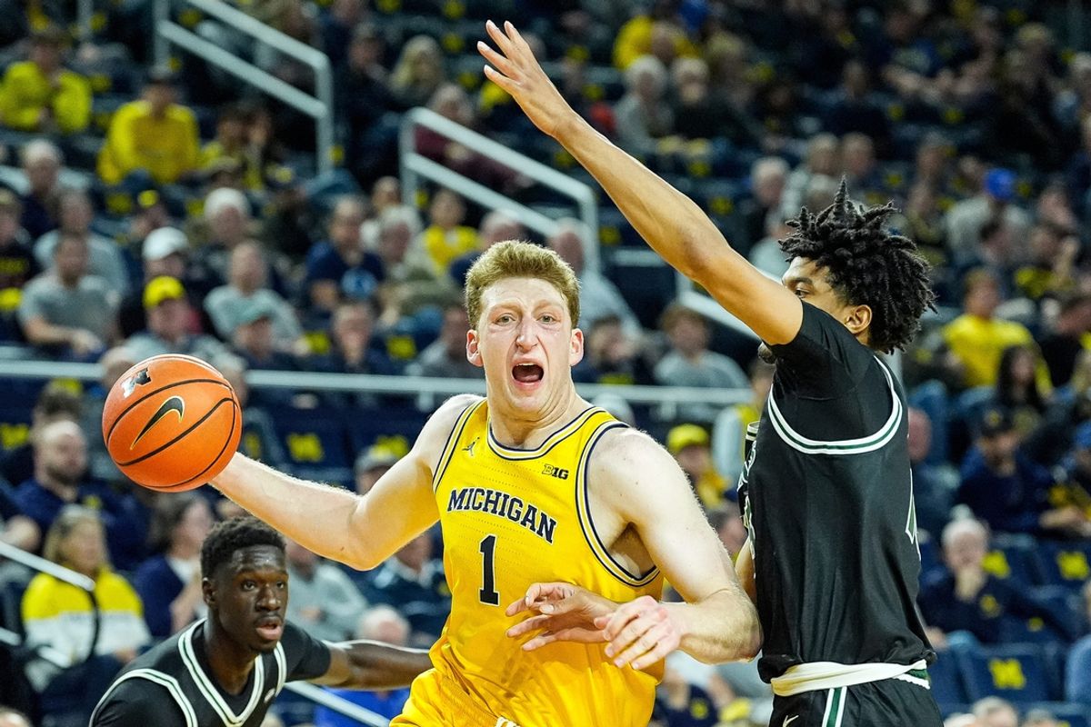 Michigan center Danny Wolf (1) dribbles against Cleveland State forward Reece Robinson (15) during the first half at Crisler Center in Ann Arbor on Monday, Nov. 4, 2024.