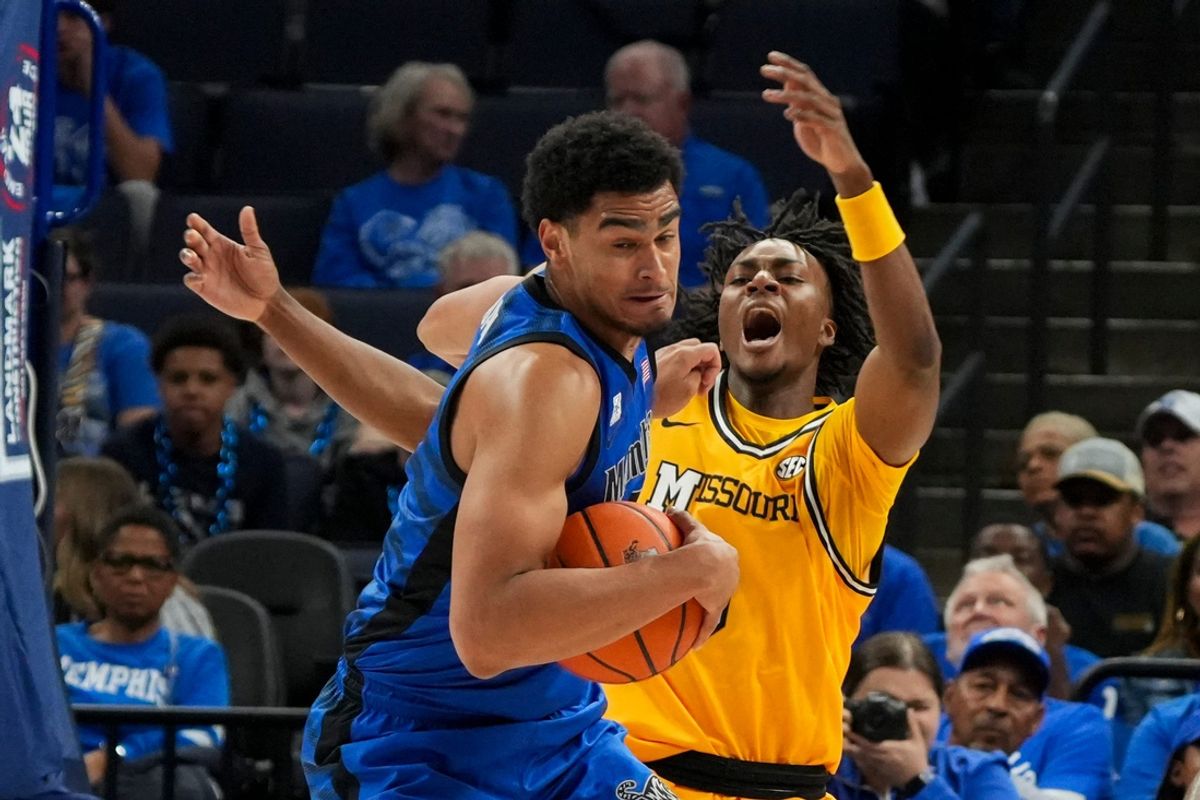Memphis' Nicholas Jourdain (2) spins away with the ball after colliding with Missouri's Anthony Robinson II (0) during the game between the University of Memphis and Missouri at FedExForum in Memphis, Tenn., on Monday, November 4, 2024.