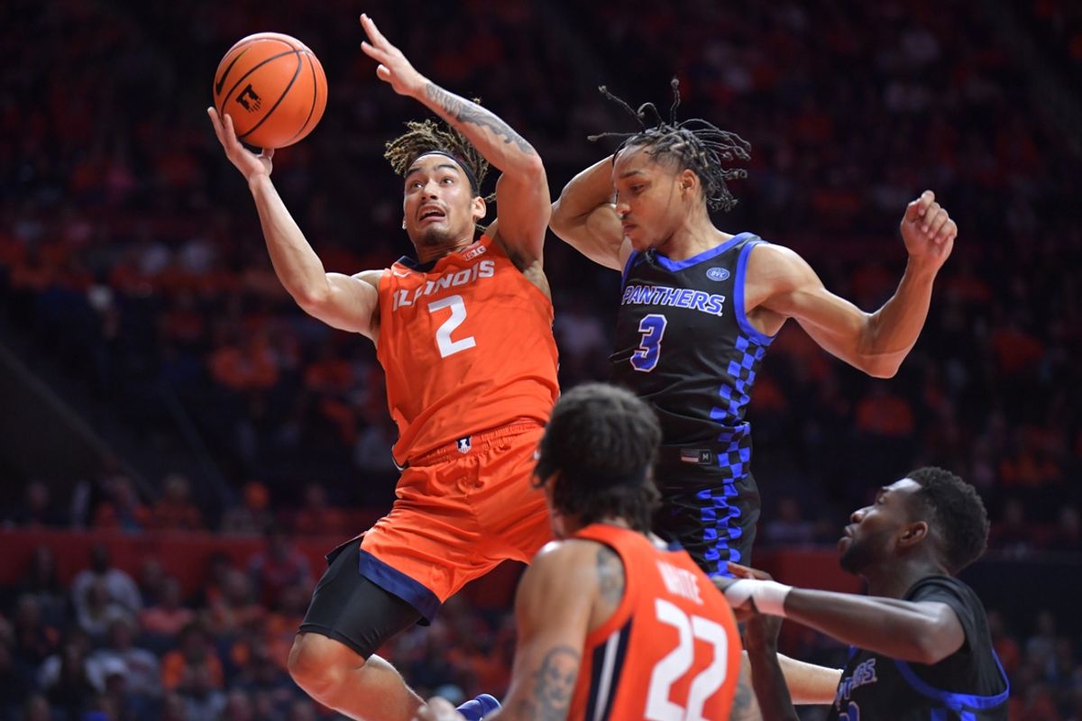 Nov 4, 2024; Champaign, Illinois, USA;  Illinois Fighting Illini guard Dra Gibbs-Lawhorn (2) drives past Eastern Illinois Panthers guard Nakyel Shelton (3) during the first half at State Farm Center. Mandatory Credit: Ron Johnson-Imagn Images