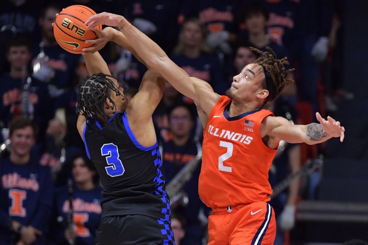 Nov 4, 2024; Champaign, Illinois, USA;  Illinois Fighting Illini guard Dra Gibbs-Lawhorn (2) tries to block the shot of Eastern Illinois Panthers guard Nakyel Shelton (3) during the first half at State Farm Center. Mandatory Credit: Ron Johnson-Imagn Images