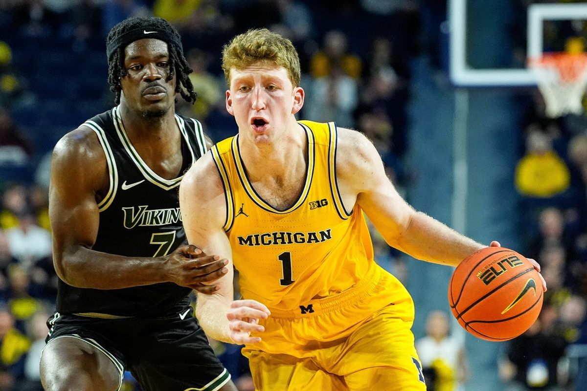 Michigan center Danny Wolf (1) dribbles against Cleveland State forward Isaac Abidde (7) during the first half at Crisler Center in Ann Arbor on Monday, Nov. 4, 2024.
