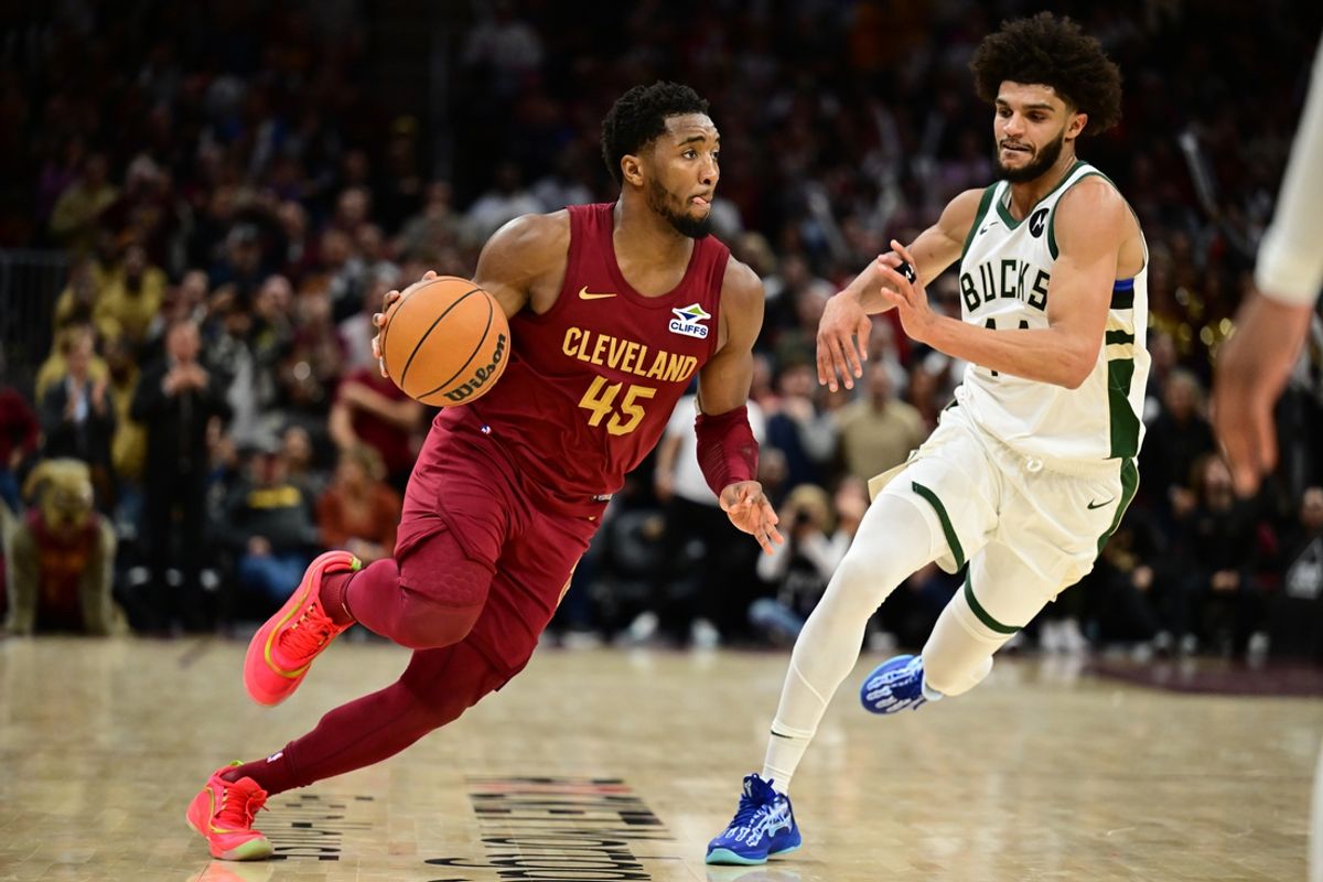 Nov 4, 2024; Cleveland, Ohio, USA; Cleveland Cavaliers guard Donovan Mitchell (45) drives to the basket against Milwaukee Bucks guard Andre Jackson Jr. (44) during the second half at Rocket Mortgage FieldHouse. Mandatory Credit: Ken Blaze-Imagn Images