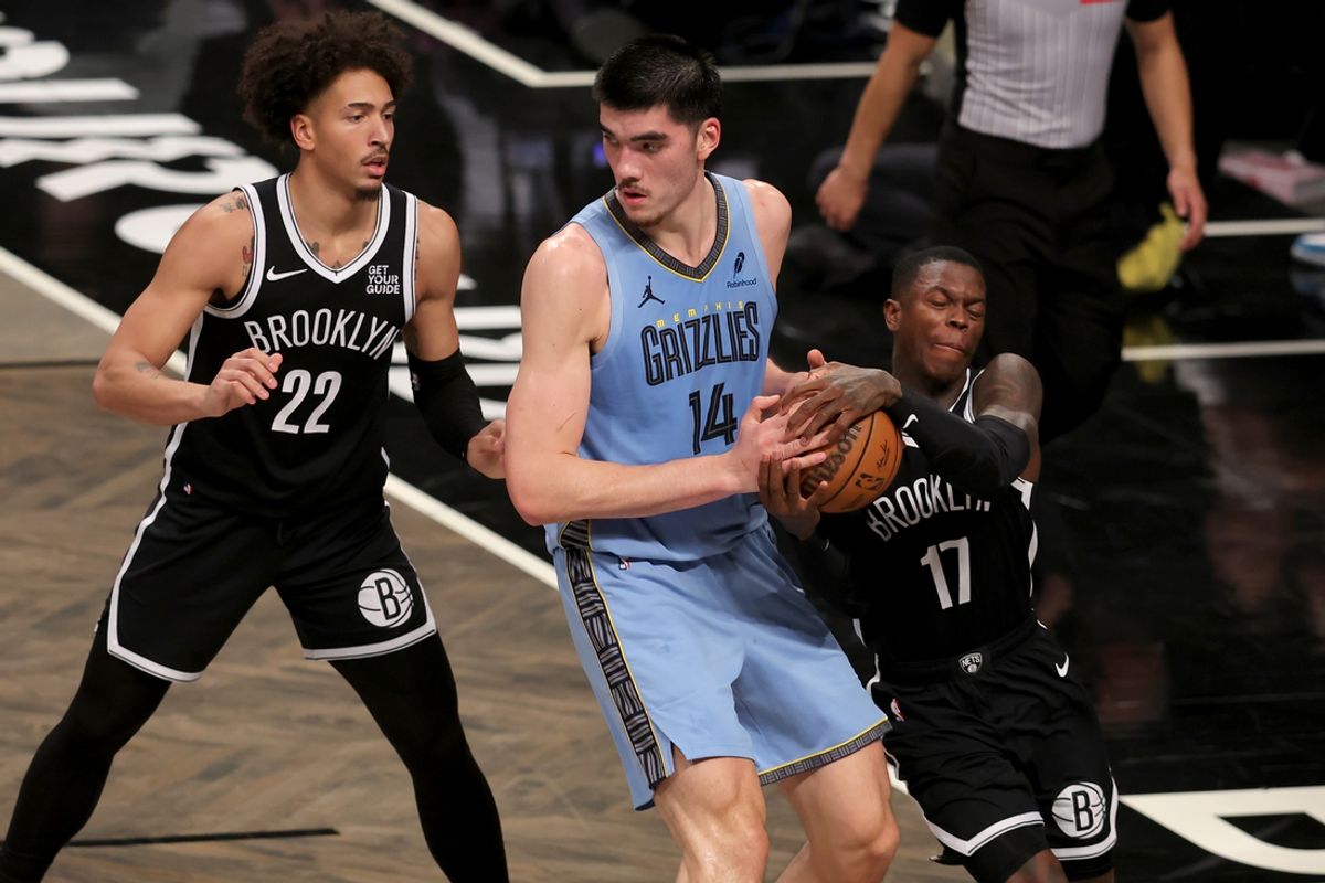 Nov 4, 2024; Brooklyn, New York, USA; Brooklyn Nets guard Dennis Schroder (17) steals the ball from Memphis Grizzlies center Zach Edey (14) in front of Nets forward Jalen Wilson (22) during the third quarter at Barclays Center. Mandatory Credit: Brad Penner-Imagn Images